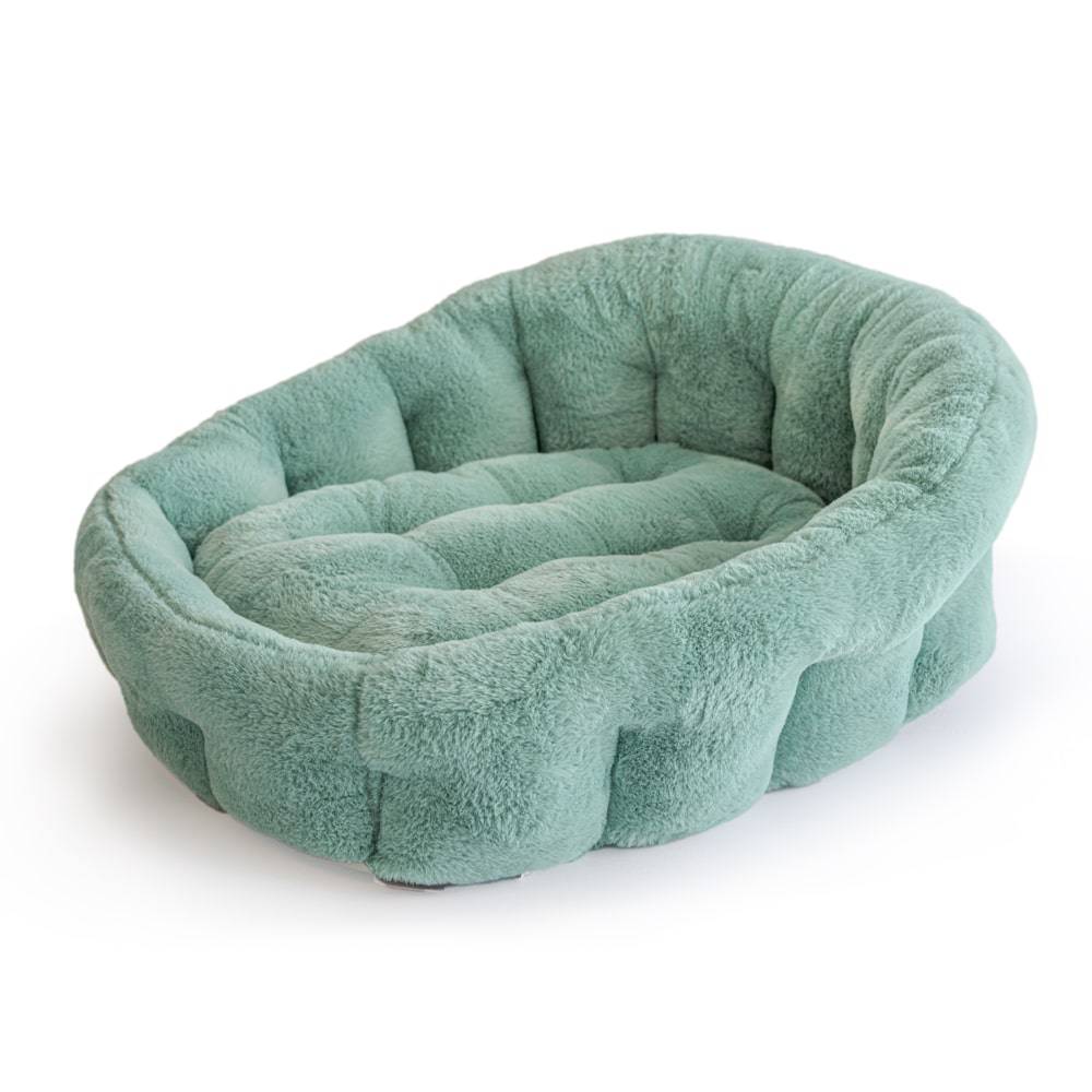 Green calming lounger dog bed by KindTail, soft and cozy resting spot for small dogs shown in the image.