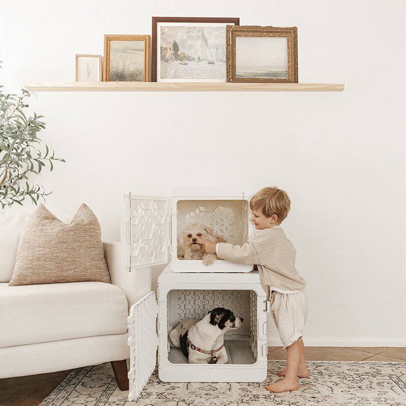 Stacked white modern pet crates by KindTail, plastic dog crates designed for medium and small dogs, featuring a collapsible design.