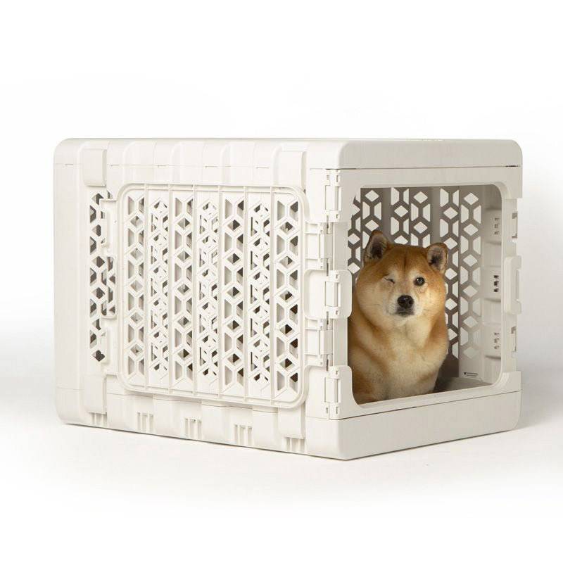 Modern collapsible plastic dog crate from PAWD® Puppy Bundle by KindTail, suitable for small to medium-sized pets.