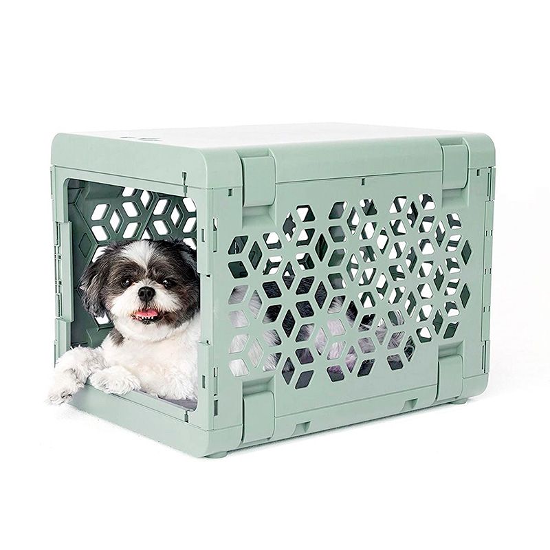 Modern collapsible plastic dog crate from PAWD® by KindTail, suitable for puppies and small pets, with a sleek design and secure door.