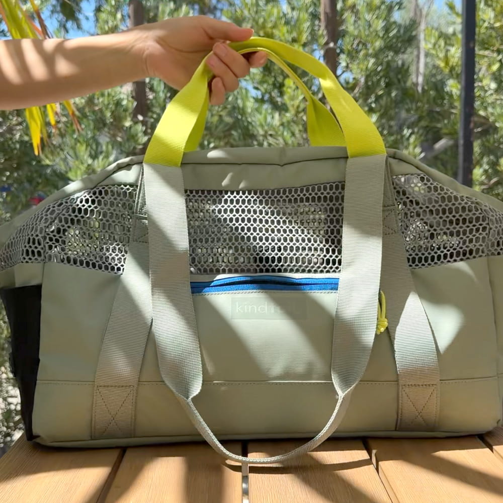 Grey KindTail PAWD dog carrier bag with breathable mesh panels and adjustable straps, designed for comfortable pet travel.